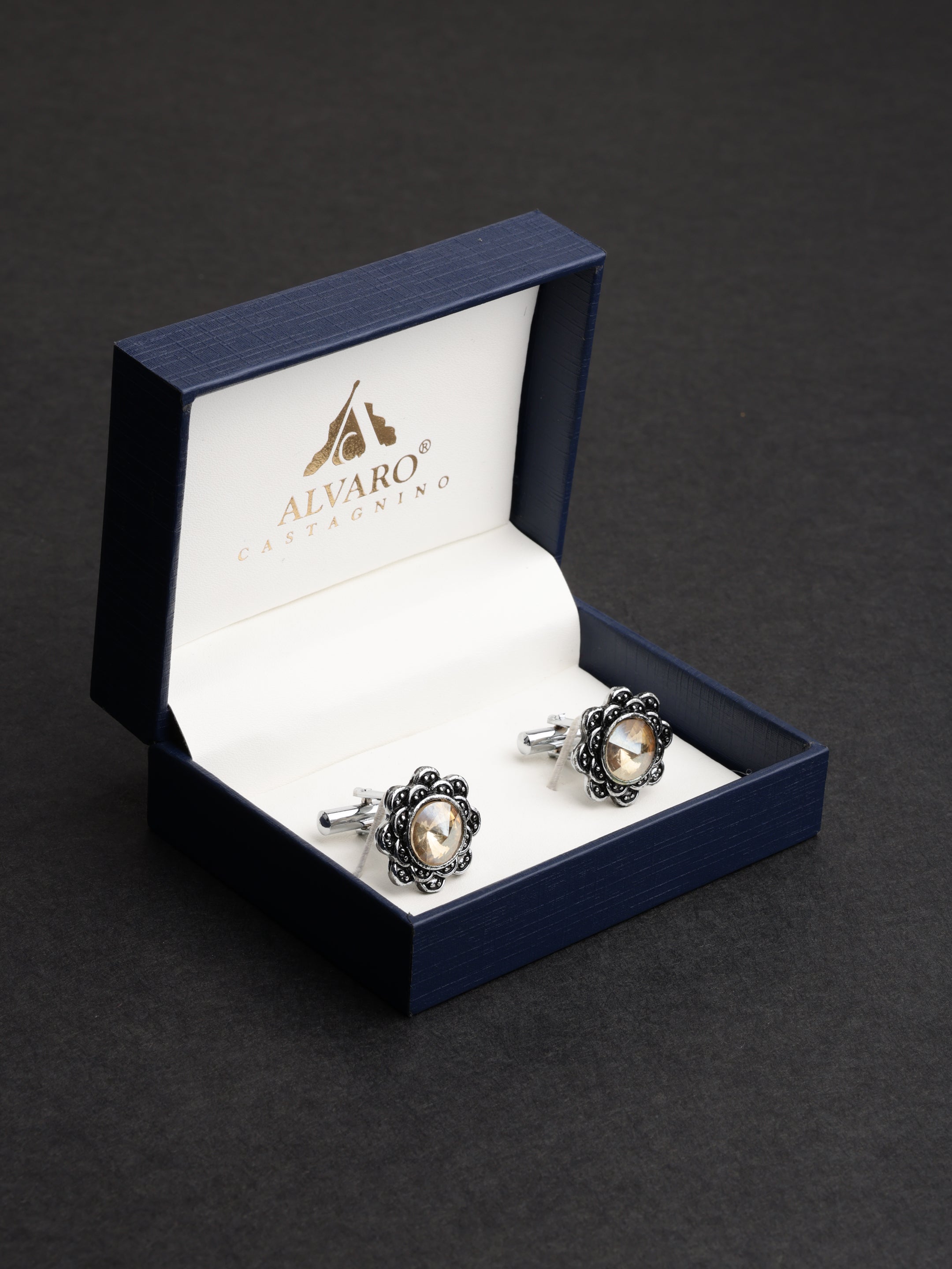 Cufflinks in a blue Alvaro Castagnino box on a dark background