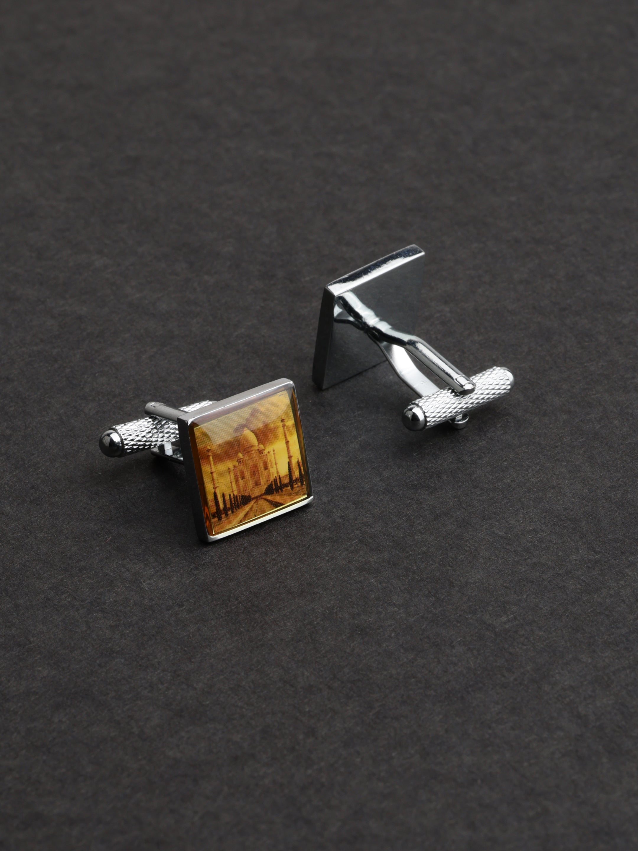 Cufflinks with a scenic design on a dark background