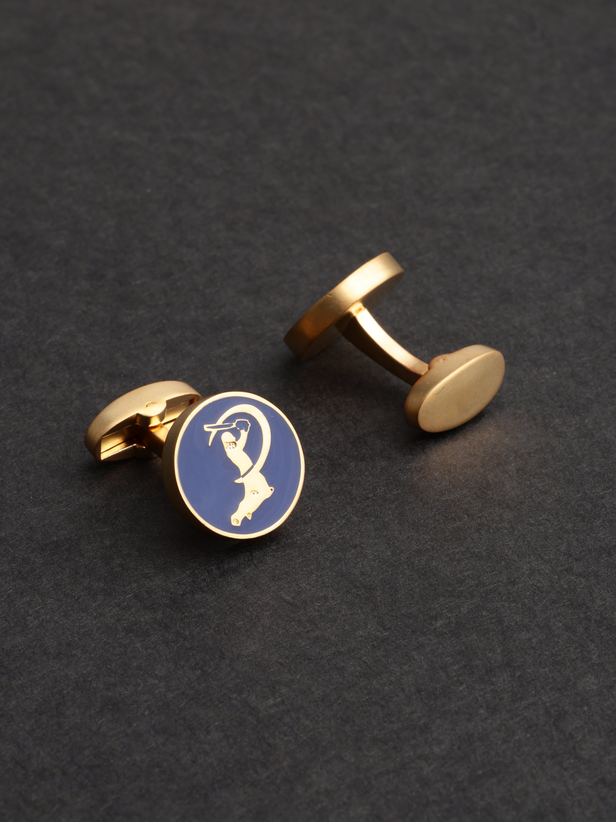Gold cufflinks with a blue round emblem featuring a golfer on a dark gray background
